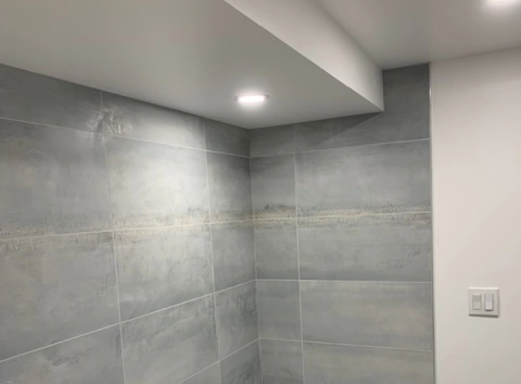 light grey shower with white ceiling and walls of a bathroom