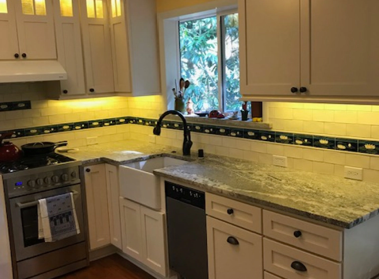 white kitchen with white cabinets and a light grey marbled cover